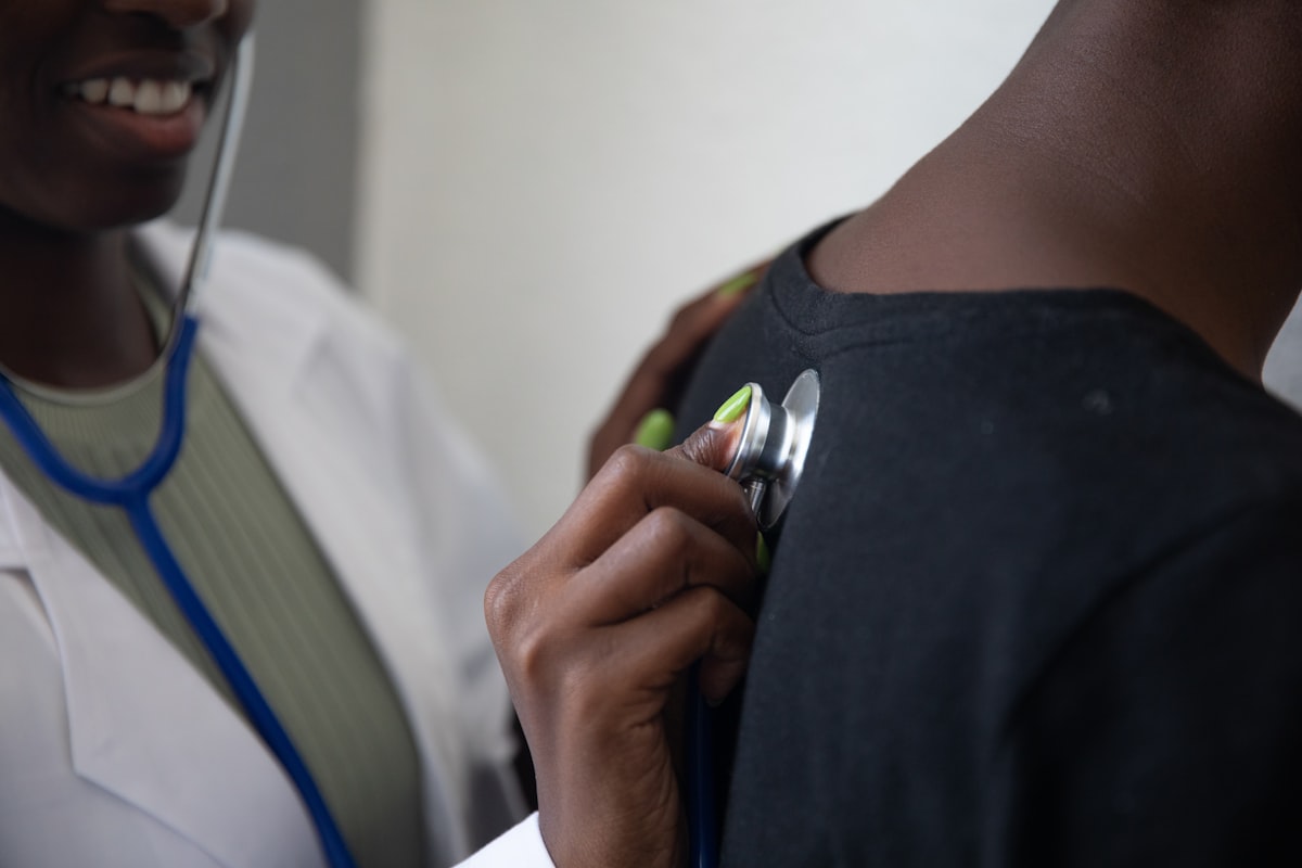Doctor examining a patient with a stethoscope, representing medical malpractice cases